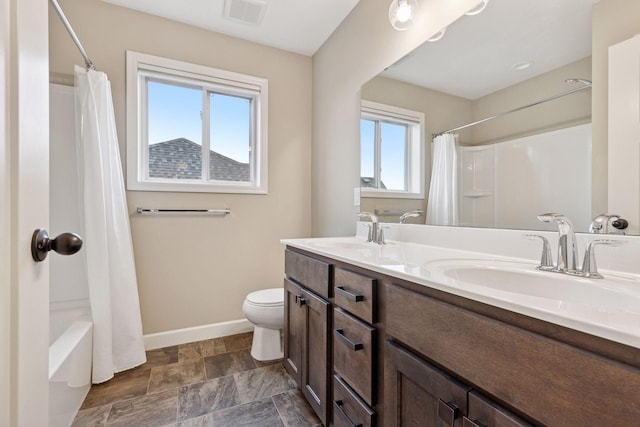 5175 White Star Ln, Woodbury, MN 55129 - bathroom featuring baseboards, double vanity, shower / bathtub combination with curtain, toilet, and stone finish flooring