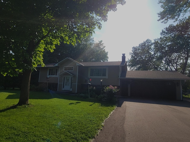 17296 Casey Ct, Prior Lake, MN 55372 - split level home with asphalt driveway, a garage, a front lawn, and a chimney