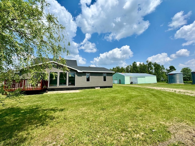 31083 County Road 4, Badger, MN 56714 - rear view of house with a yard, an outdoor structure, a pole building, and a wooden deck