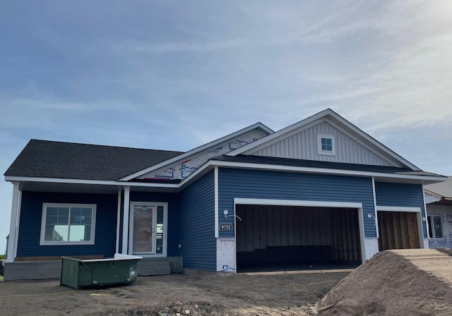 9752 32nd St NE, Saint Michael, MN 55376 - view of front of house with an attached garage, board and batten siding, driveway, and roof with shingles