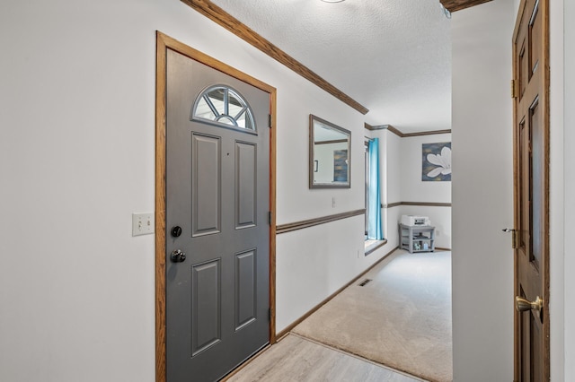 4142 Joppa Cir, Savage, MN 55378 - foyer entrance with crown molding, light wood-style floors, plenty of natural light, a textured ceiling, and baseboards
