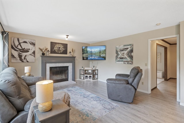 4142 Joppa Cir, Savage, MN 55378 - living room with light wood finished floors, a brick fireplace, and baseboards