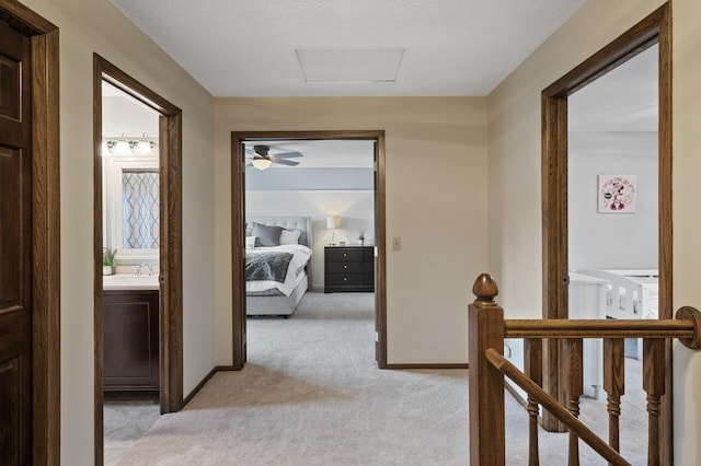 4142 Joppa Cir, Savage, MN 55378 - hall with light colored carpet, an upstairs landing, attic access, a sink, and baseboards