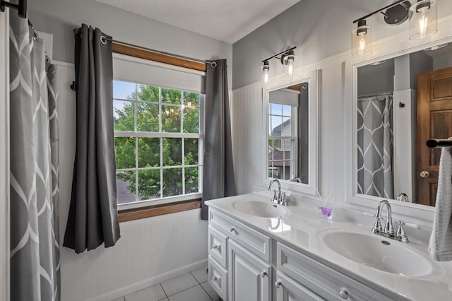 4142 Joppa Cir, Savage, MN 55378 - bathroom with tile patterned floors, double vanity, plenty of natural light, and a textured ceiling