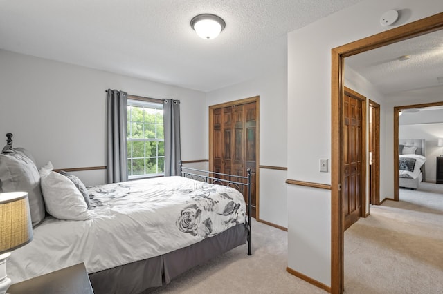 4142 Joppa Cir, Savage, MN 55378 - bedroom featuring light colored carpet, a textured ceiling, a closet, and baseboards