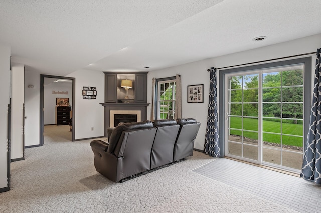 4142 Joppa Cir, Savage, MN 55378 - living room with a textured ceiling, baseboards, a tile fireplace, and light colored carpet
