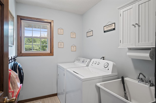 4142 Joppa Cir, Savage, MN 55378 - laundry room with separate washer and dryer, baseboards, and a textured ceiling