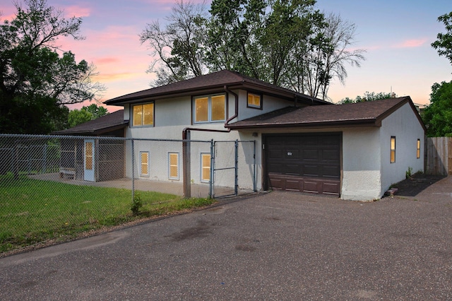 2125 White Bear Ave N, Maplewood, MN 55109 - view of front of property featuring stucco siding, a garage, asphalt driveway, and a shingled roof