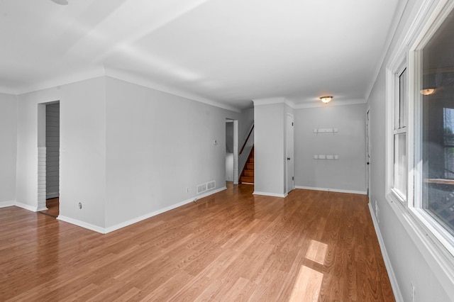 2125 White Bear Ave N, Maplewood, MN 55109 - spare room with stairs, light wood finished floors, and baseboards