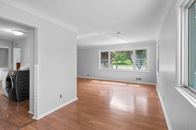 2125 White Bear Ave N, Maplewood, MN 55109 - spare room with washer / dryer, wood finished floors, and baseboards