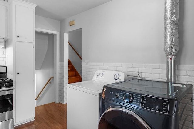 2125 White Bear Ave N, Maplewood, MN 55109 - washroom with washer and dryer and wood finished floors
