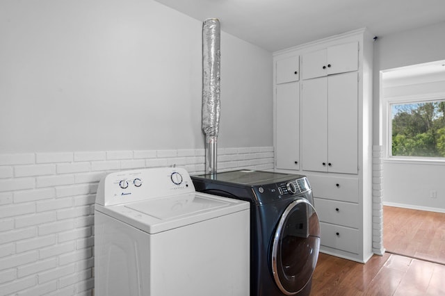 2125 White Bear Ave N, Maplewood, MN 55109 - washroom featuring washer and dryer, wood finished floors, and wainscoting