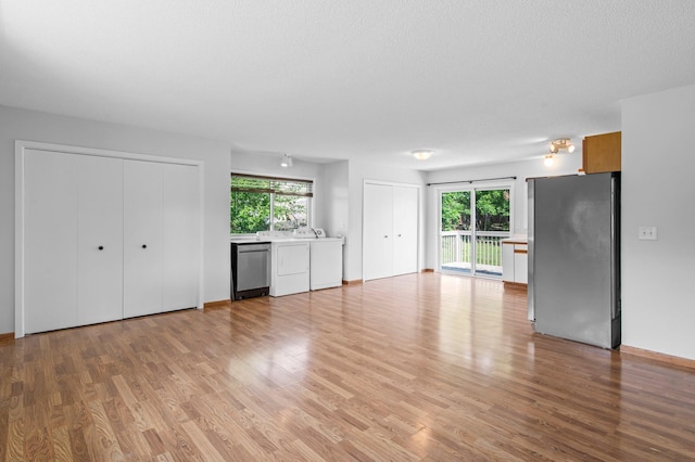 2125 White Bear Ave N, Maplewood, MN 55109 - unfurnished living room with healthy amount of natural light and light wood finished floors