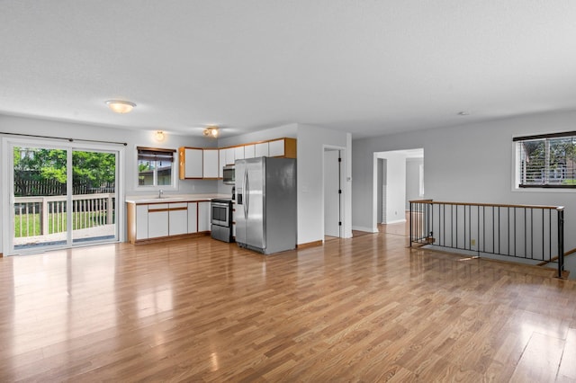 2125 White Bear Ave N, Maplewood, MN 55109 - kitchen with appliances with stainless steel finishes, plenty of natural light, a sink, and light countertops