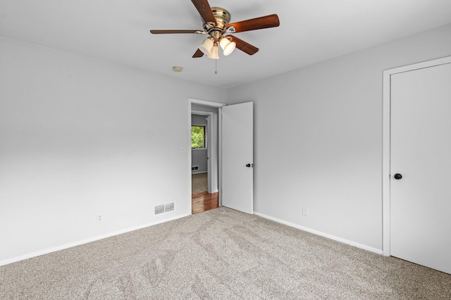 2125 White Bear Ave N, Maplewood, MN 55109 - unfurnished bedroom with carpet floors, baseboards, and ceiling fan
