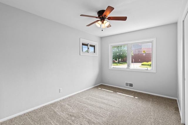 2125 White Bear Ave N, Maplewood, MN 55109 - spare room featuring carpet floors, baseboards, and a ceiling fan