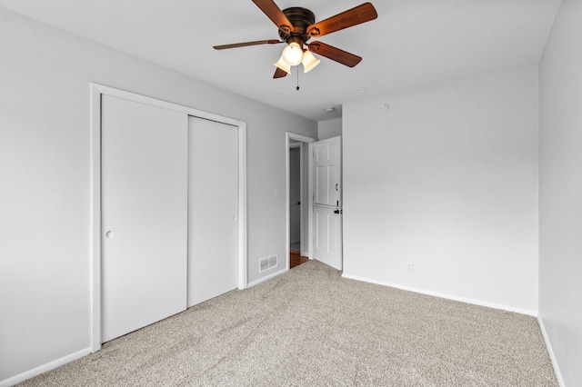 2125 White Bear Ave N, Maplewood, MN 55109 - unfurnished bedroom with carpet flooring, baseboards, a closet, and ceiling fan