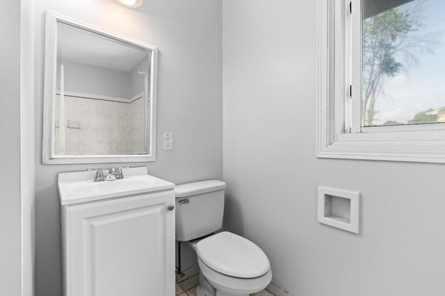 2125 White Bear Ave N, Maplewood, MN 55109 - bathroom with toilet, vanity, and plenty of natural light