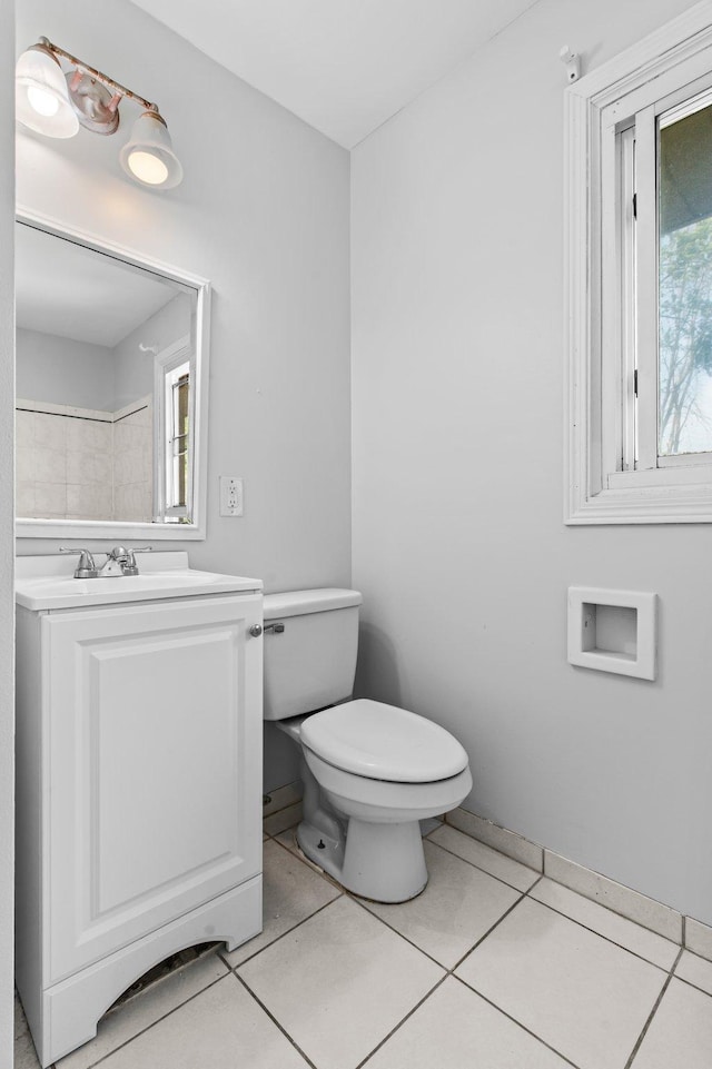 2125 White Bear Ave N, Maplewood, MN 55109 - bathroom featuring toilet, healthy amount of natural light, vanity, and tile patterned floors
