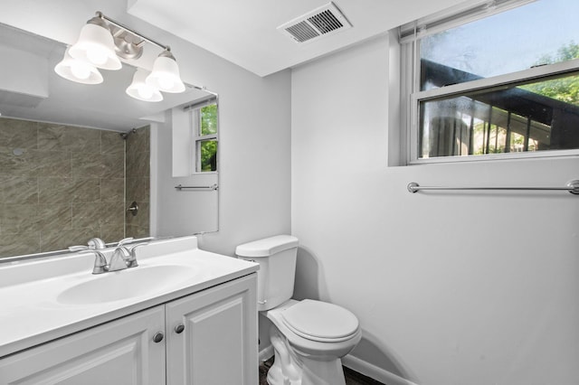 2125 White Bear Ave N, Maplewood, MN 55109 - bathroom with vanity, toilet, and a shower