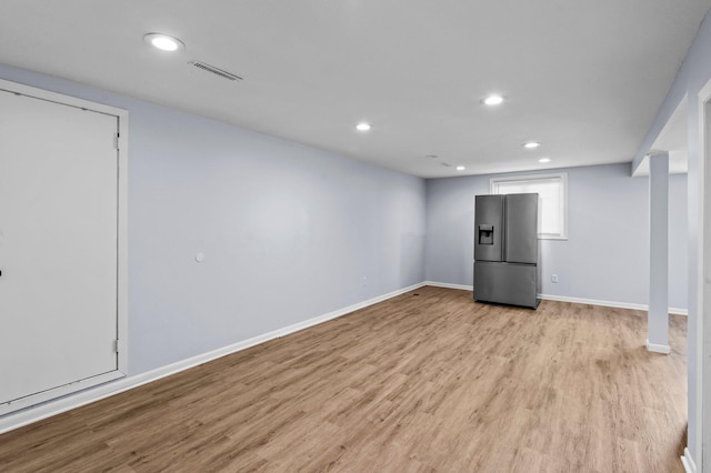2125 White Bear Ave N, Maplewood, MN 55109 - basement featuring stainless steel refrigerator with ice dispenser, light wood-style floors, recessed lighting, and baseboards