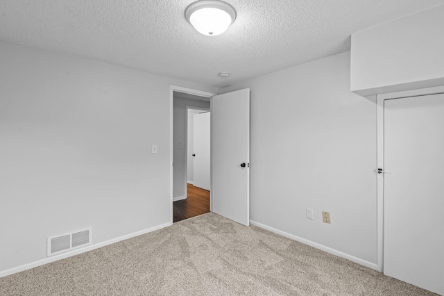2125 White Bear Ave N, Maplewood, MN 55109 - unfurnished bedroom featuring carpet, a textured ceiling, and baseboards