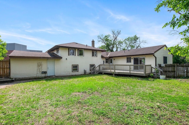 2125 White Bear Ave N, Maplewood, MN 55109 - back of house featuring a wooden deck, a chimney, and stucco siding