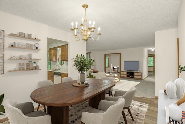 2 Crusader Ave E Unit A, West Saint Paul, MN 55118 - dining space featuring a chandelier, light wood-type flooring, and a textured ceiling