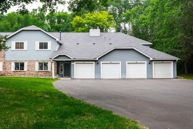 2 Crusader Ave E Unit A, West Saint Paul, MN 55118 - view of front of property featuring a chimney, a shingled roof, a front yard, and brick siding