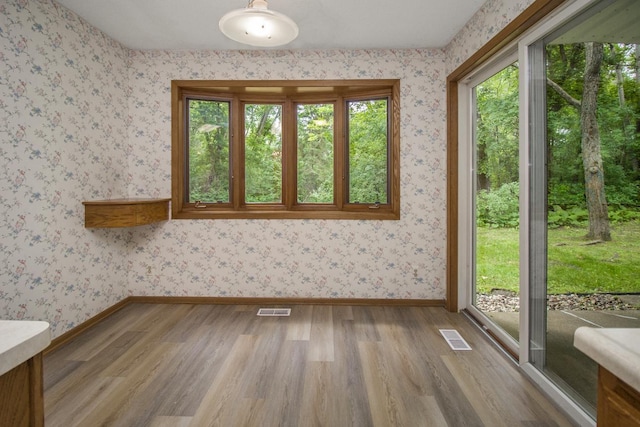 2 Crusader Ave E Unit A, West Saint Paul, MN 55118 - unfurnished room featuring wood finished floors and wallpapered walls