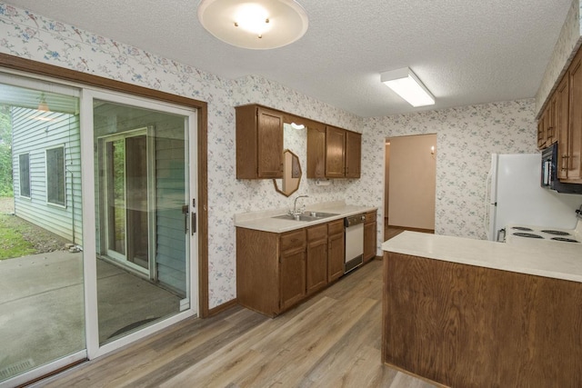 2 Crusader Ave E Unit A, West Saint Paul, MN 55118 - kitchen with wallpapered walls, white appliances, light wood-style floors, a textured ceiling, and light countertops