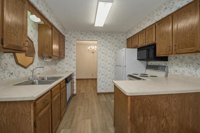2 Crusader Ave E Unit A, West Saint Paul, MN 55118 - kitchen featuring black microwave, stove, light wood-type flooring, wallpapered walls, and brown cabinets