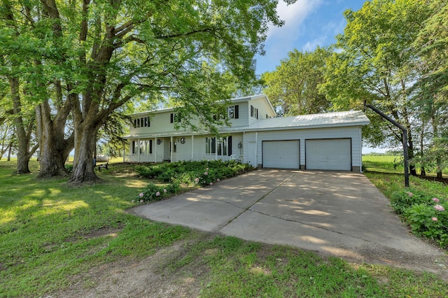 37875 600th Ave, Eden Valley, MN 55329 - view of front facade featuring a garage, concrete driveway, a front lawn, and a metal roof