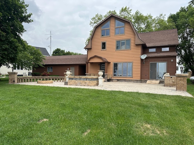 70 Lakeview Dr, Slayton, MN 56172 - back of house featuring a shingled roof, a lawn, a gambrel roof, and a patio
