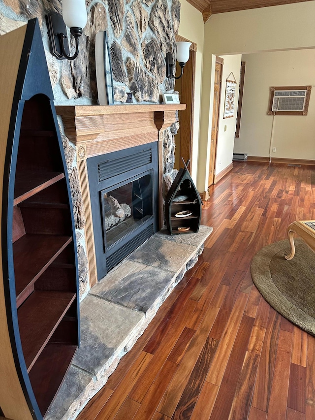 70 Lakeview Dr, Slayton, MN 56172 - detailed view of an AC wall unit, wood finished floors, a fireplace, ornamental molding, and baseboards