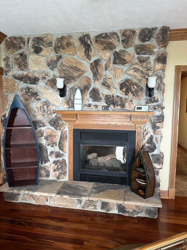 70 Lakeview Dr, Slayton, MN 56172 - detailed view of wood finished floors, a fireplace, a textured ceiling, and baseboards