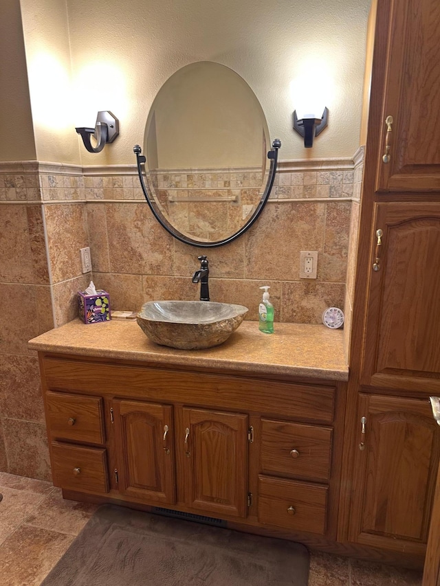 70 Lakeview Dr, Slayton, MN 56172 - bathroom with vanity, tile walls, and a wainscoted wall