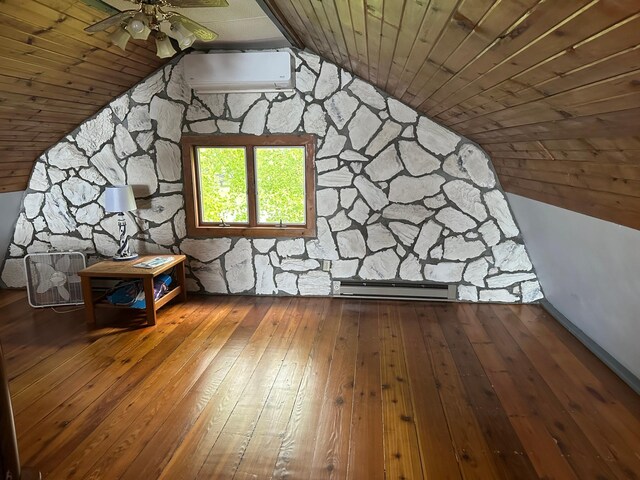 70 Lakeview Dr, Slayton, MN 56172 - additional living space with a baseboard radiator, a wall mounted AC, wood-type flooring, vaulted ceiling, and wooden ceiling