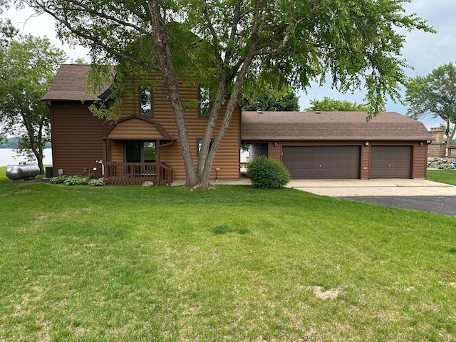 70 Lakeview Dr, Slayton, MN 56172 - view of front of house with asphalt driveway, a front yard, a shingled roof, and a garage