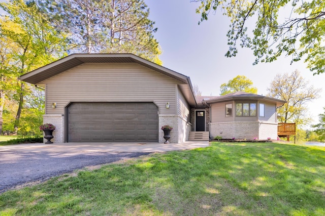 25397 Island View Dr, Cohasset, MN 55721 - view of front of house featuring brick siding, asphalt driveway, a garage, and a front yard