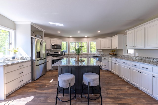 25397 Island View Dr, Cohasset, MN 55721 - kitchen with stainless steel appliances, a kitchen island, white cabinetry, recessed lighting, and dark wood finished floors