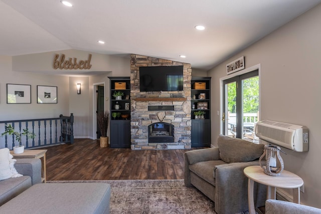 25397 Island View Dr, Cohasset, MN 55721 - living room featuring lofted ceiling, wood finished floors, a stone fireplace, a wall mounted air conditioner, and baseboards