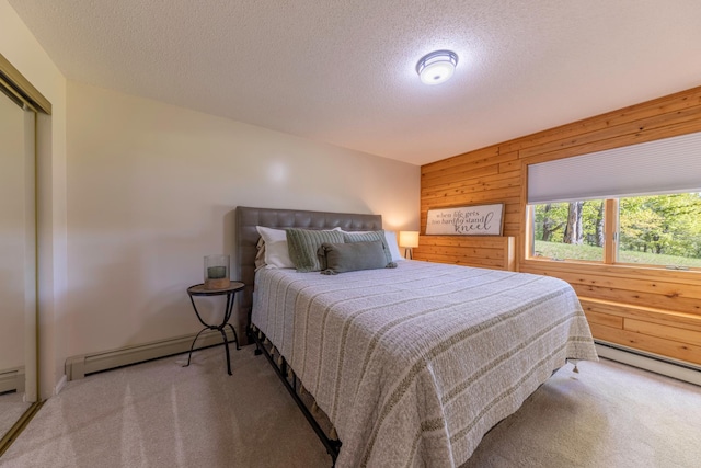 25397 Island View Dr, Cohasset, MN 55721 - bedroom with carpet floors, wooden walls, baseboard heating, a textured ceiling, and a baseboard heating unit