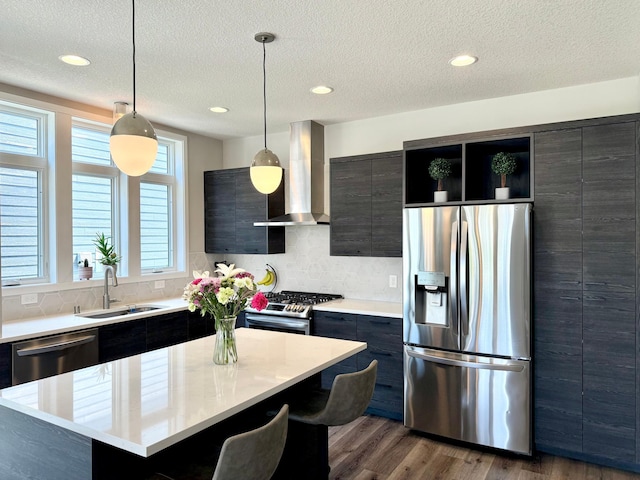 4848 161st St W, Lakeville, MN 55044 - kitchen featuring appliances with stainless steel finishes, a sink, wall chimney range hood, light countertops, and backsplash