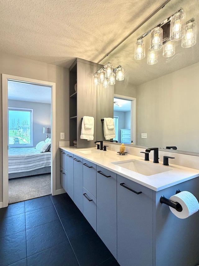 4848 161st St W, Lakeville, MN 55044 - full bathroom with ensuite bathroom, double vanity, a textured ceiling, and tile patterned flooring