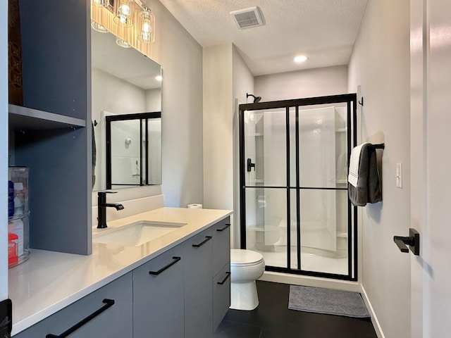 4848 161st St W, Lakeville, MN 55044 - bathroom featuring toilet, a shower stall, vanity, and a textured ceiling