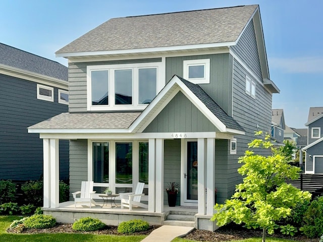 4848 161st St W, Lakeville, MN 55044 - view of front of home featuring a porch, a shingled roof, and board and batten siding