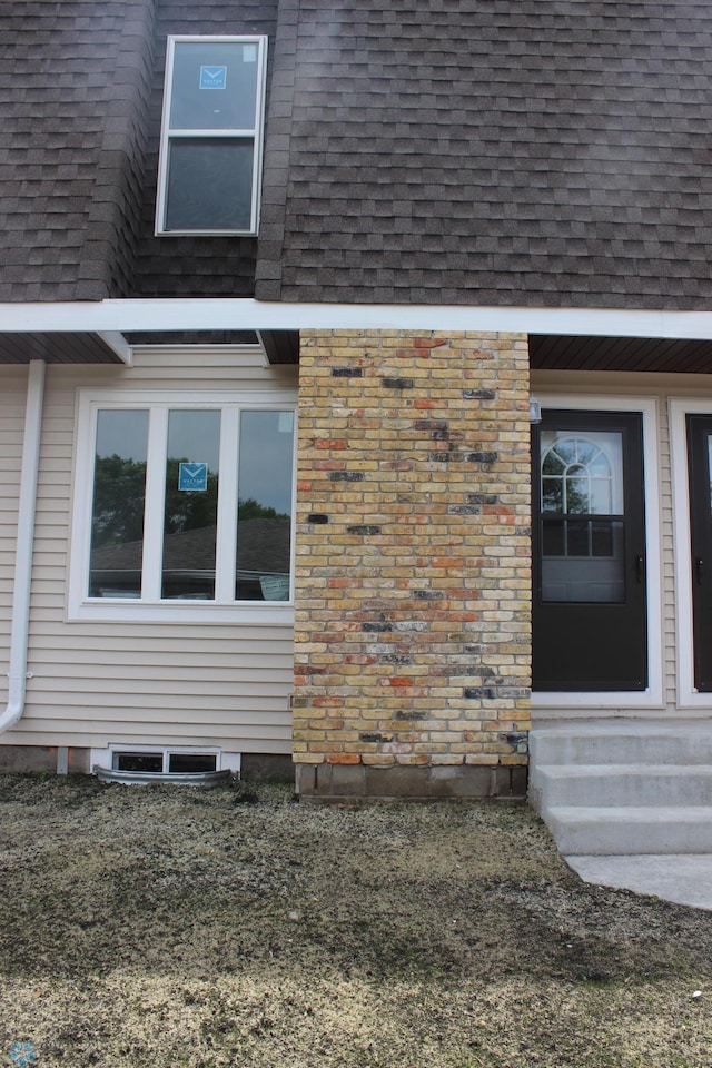 235 12 1/2 Ave E, West Fargo, ND 58078 - view of side of home featuring roof with shingles and entry steps