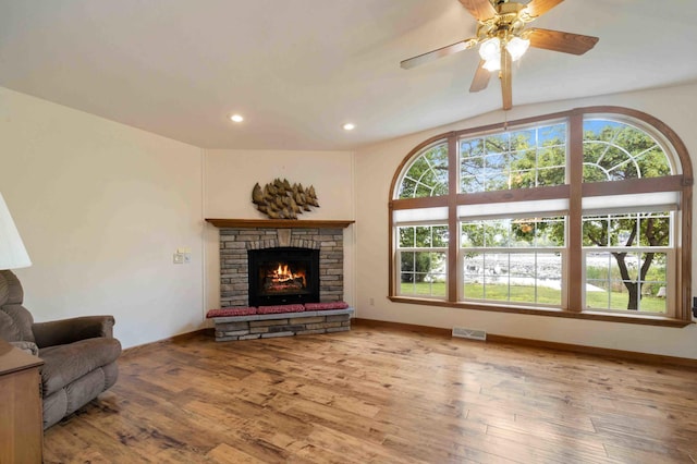 505 Superior Ave, Crosby, MN 56441 - living area with wood finished floors, recessed lighting, a stone fireplace, and a ceiling fan