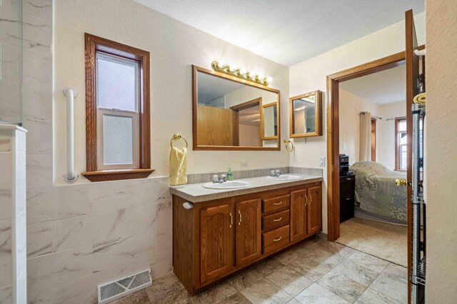 505 Superior Ave, Crosby, MN 56441 - full bath featuring double vanity, ensuite bath, and tile walls